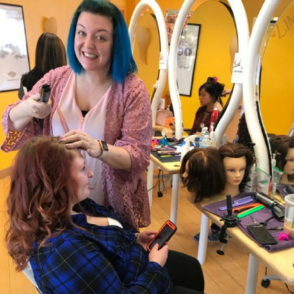 cosmetology student curling hair