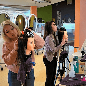 Girls working on manikins students practicing on manikins
